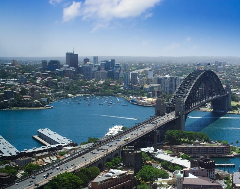 an aerial view of the Sydney Harbour Bridge and the surrounding harbour