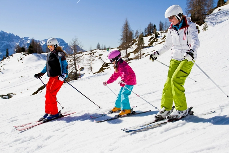 a family of girls skiing down a slope