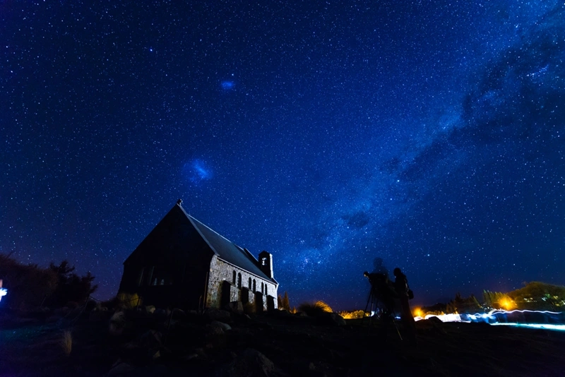 photo of the milky way nightscape with a building in the foreground