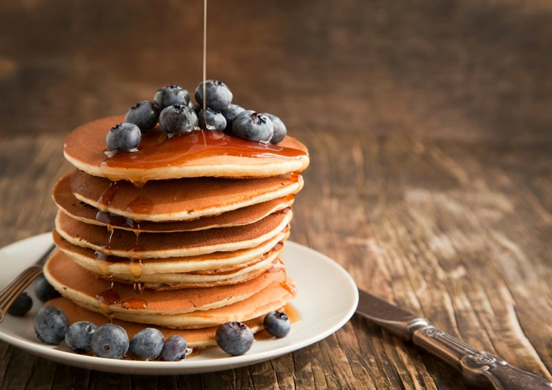 a stack of pancakes with blueberries