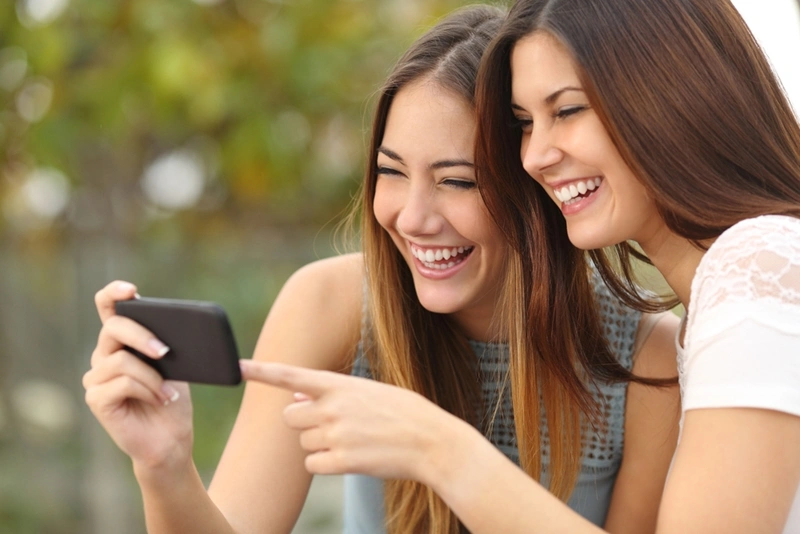 ladies smiling at a phone screen