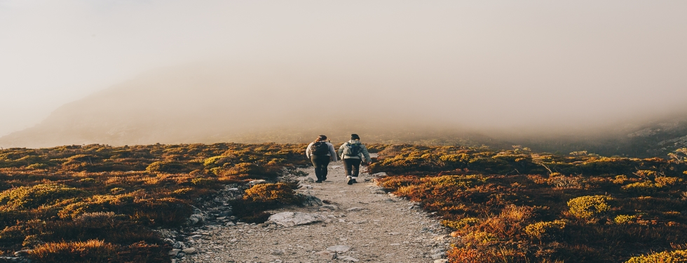 Two women walking through Cradle Mountain National Park in Tasmania