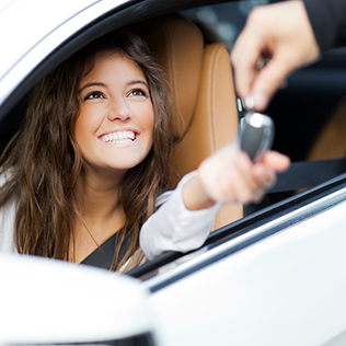 Young woman receiving keys