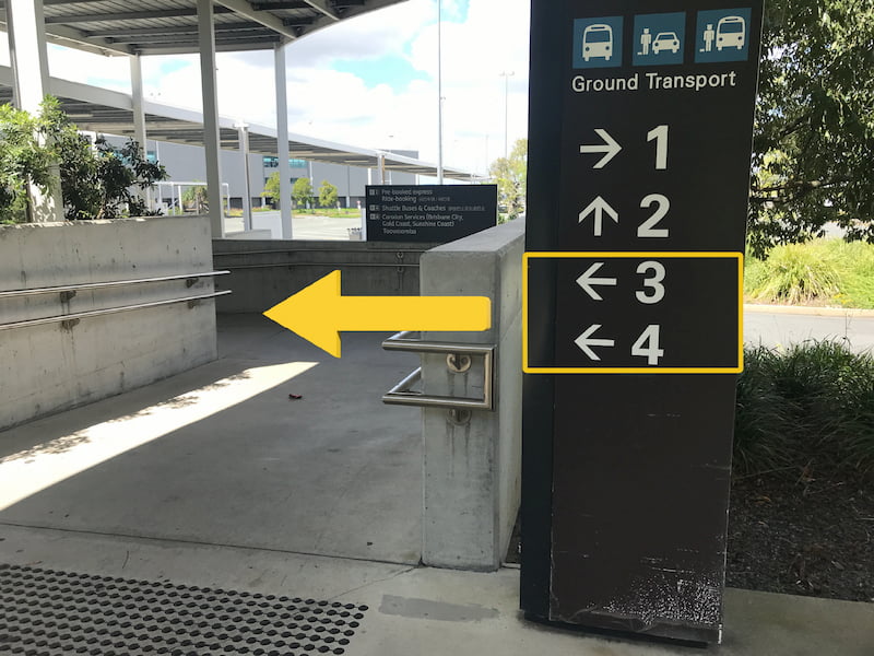 Airport directional sign pointing to the left for Ground Transport Pickup.