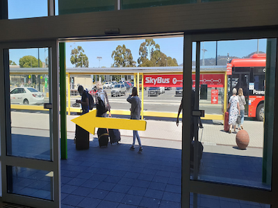 Glass doors opening to outside - a yellow arrow is indicating to turn left.