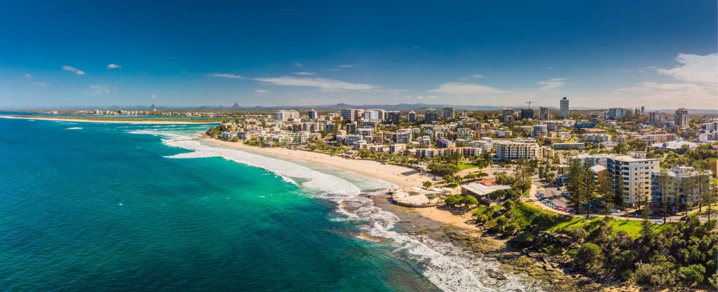 Ariel photo above the ocean and city | Featured image for How to Enjoy a 4 Day Sunshine Coast Road Trip.