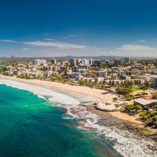 Ariel photo above the ocean and city | Featured image for How to Enjoy a 4 Day Sunshine Coast Road Trip.