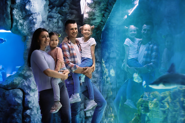 Happy family at aquarium.
