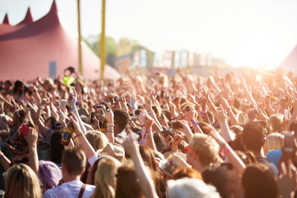 Audience at outdoor music festival | Featured image for the Must See Regional Festivals blog for East Coast Car Rentals.